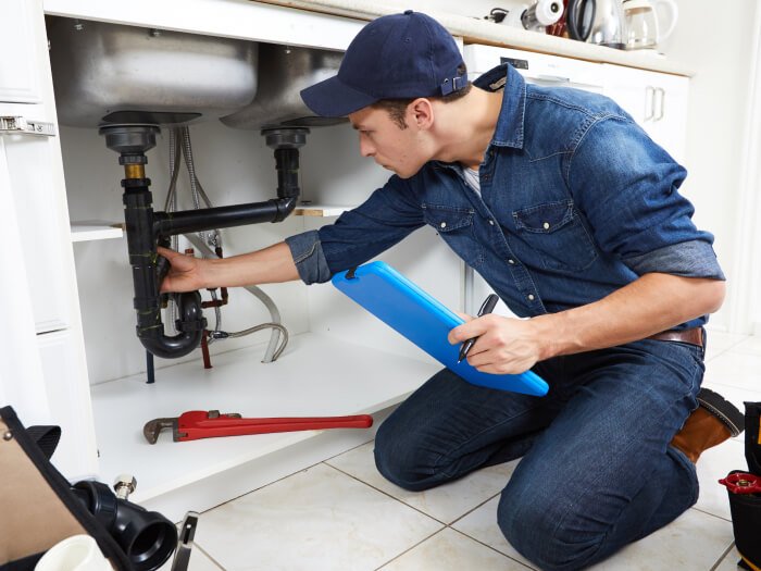 Plumber assessing kitchen sink